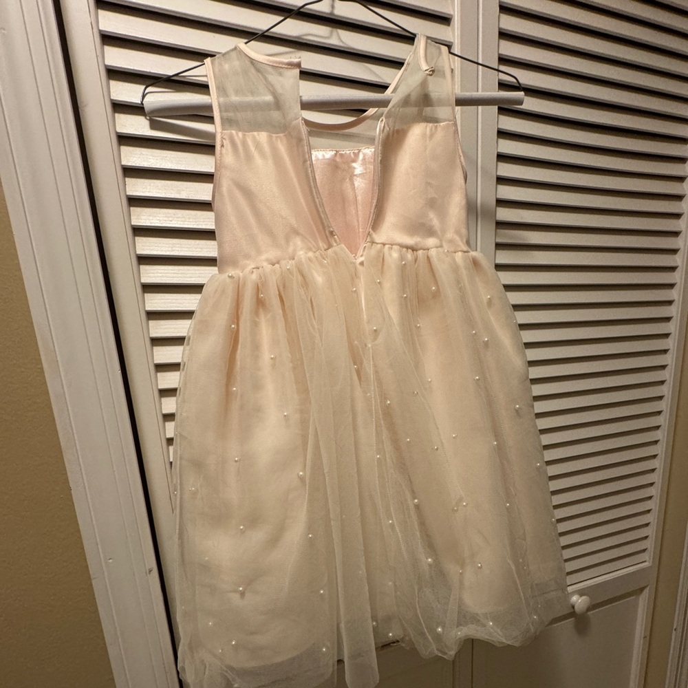 Gorgeous pink dress with pearl accents. Great for any event.